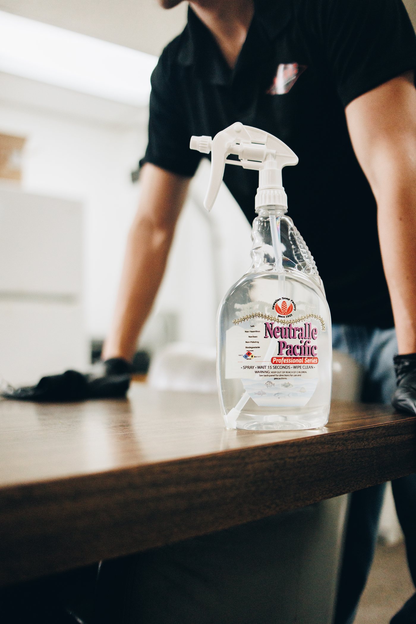 Neutralle Pacific spray bottle on a counter being wiped down