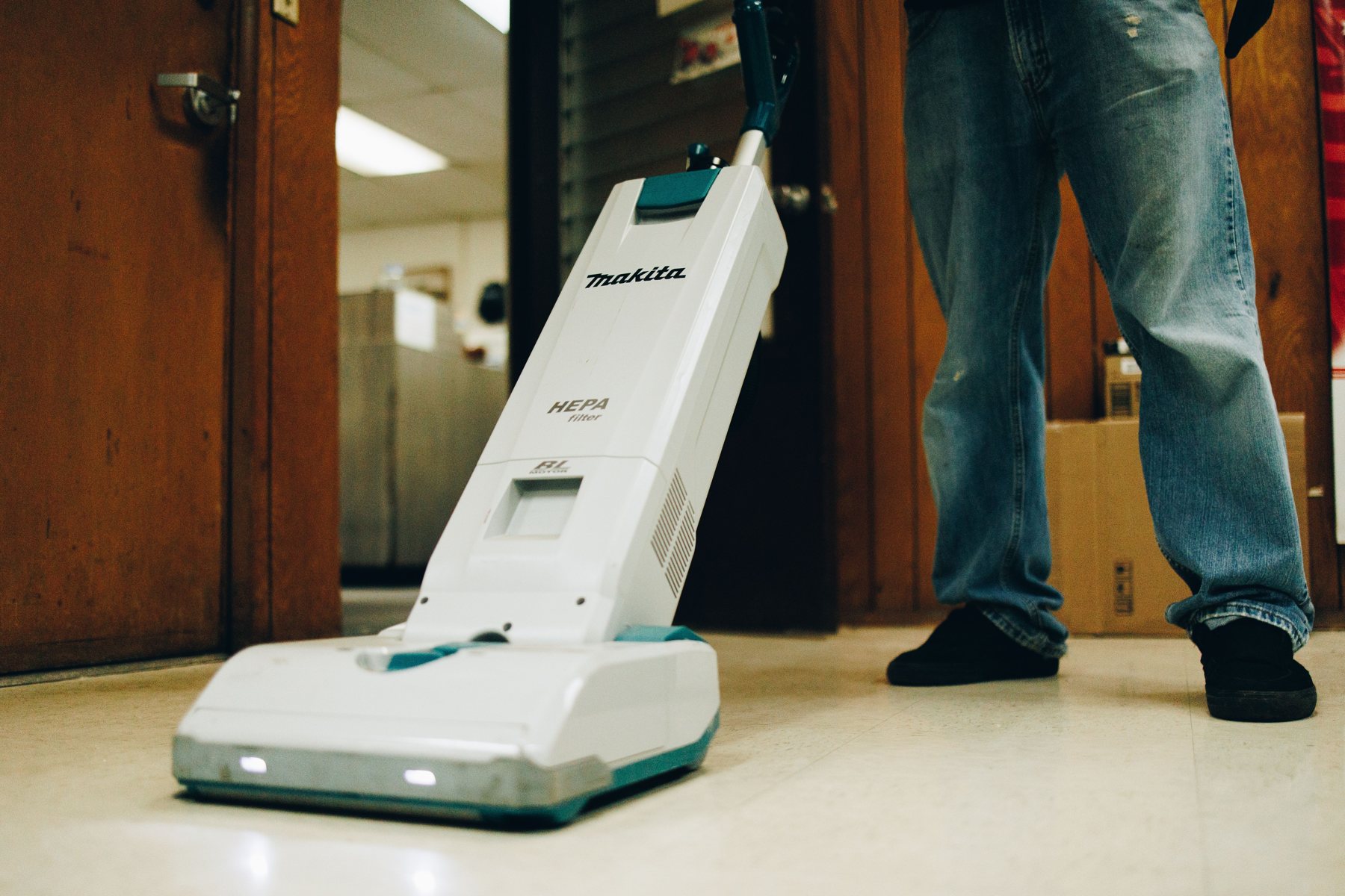 ABC team member vacuuming an office floor